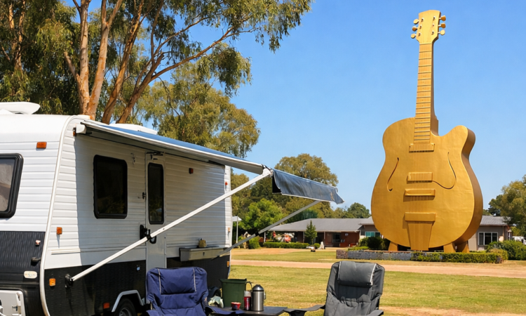 Caravan at a Tamworth holiday park near the Big Golden Guitar with camping setup