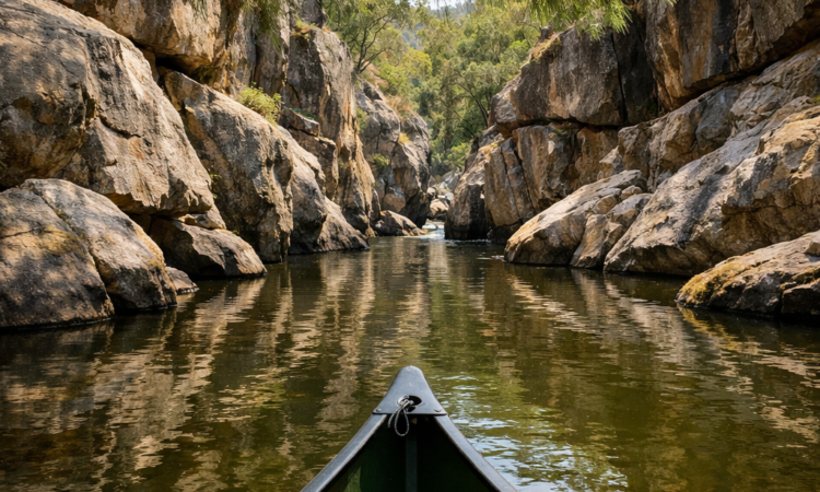 Canoe paddling through granite gorge on Namoi River in Warrabah National Park