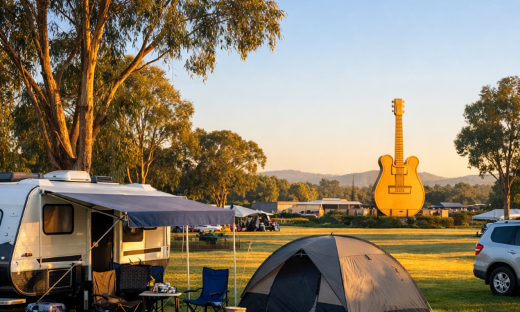 Caravan at holiday park near Big Golden Guitar Tamworth with iconic landmark visible in distance