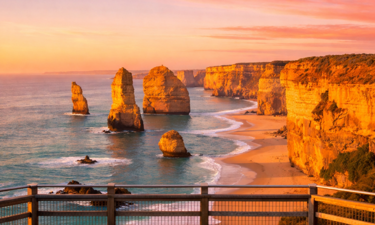 Twelve Apostles at sunrise on the Great Ocean Road with golden light and empty viewing platform