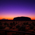 Sunrise at Uluru viewed from Talinguru Nyakunytjaku platform with changing sky colours over the monolith