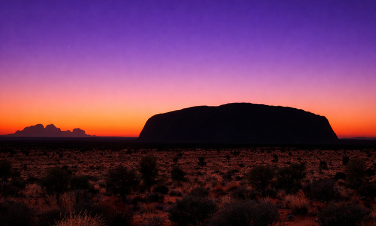 Sunrise at Uluru viewed from Talinguru Nyakunytjaku platform with changing sky colours over the monolith